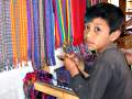 Child learning to weave